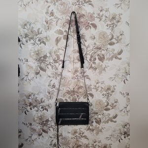 Rebecca Minkoff black purse with silver hardware and studs at the bottom